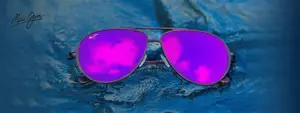 Purple sunglasses on blue water surface with a watermark