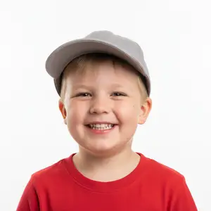A young boy with a gray cap and red shirt smiling for a photo