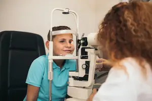 A young boy getting an eye exam in an office