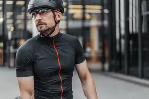 A man wearing a helmet and sunglasses on a street