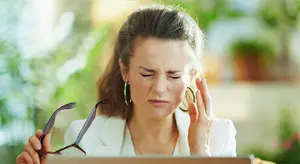 woman with eye strain looking at computer monitor
